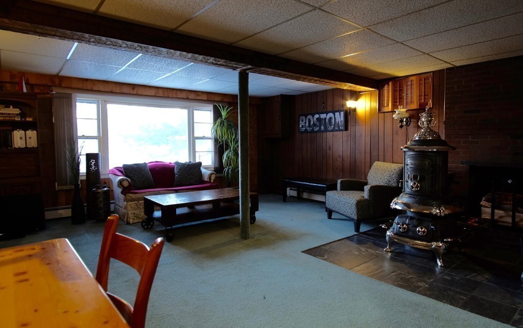 182 Governors Road Quincy, MA 02169 - Photo 14 of 15 a living room with furniture a flat screen tv and gym equipment