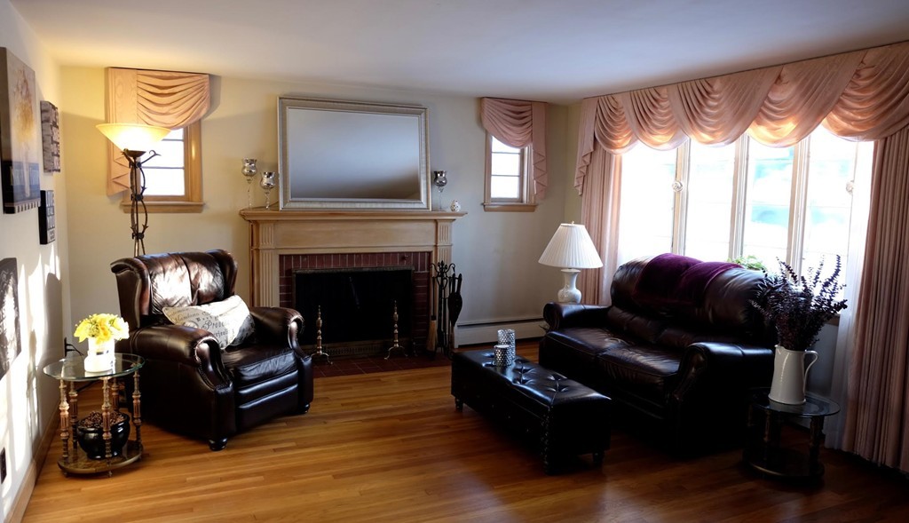 182 Governors Road Quincy, MA 02169 - Photo 2 of 15 a living room with furniture and a fireplace