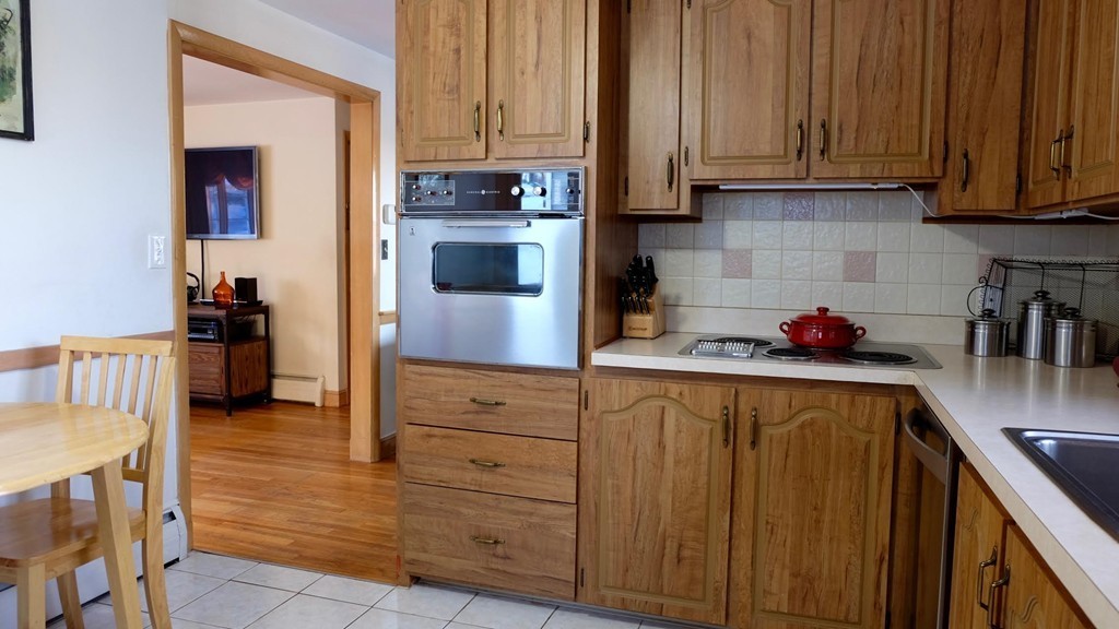 182 Governors Road Quincy, MA 02169 - Photo 5 of 15 a kitchen with stainless steel appliances granite countertop a refrigerator and a stove top oven