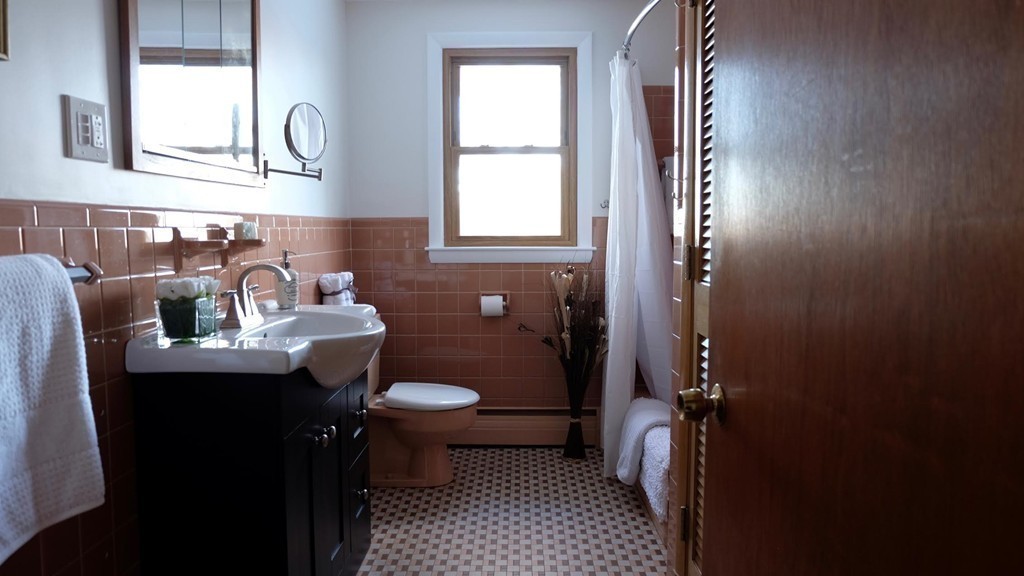 182 Governors Road Quincy, MA 02169 - Photo 9 of 15 a bathroom with a sink and a mirror