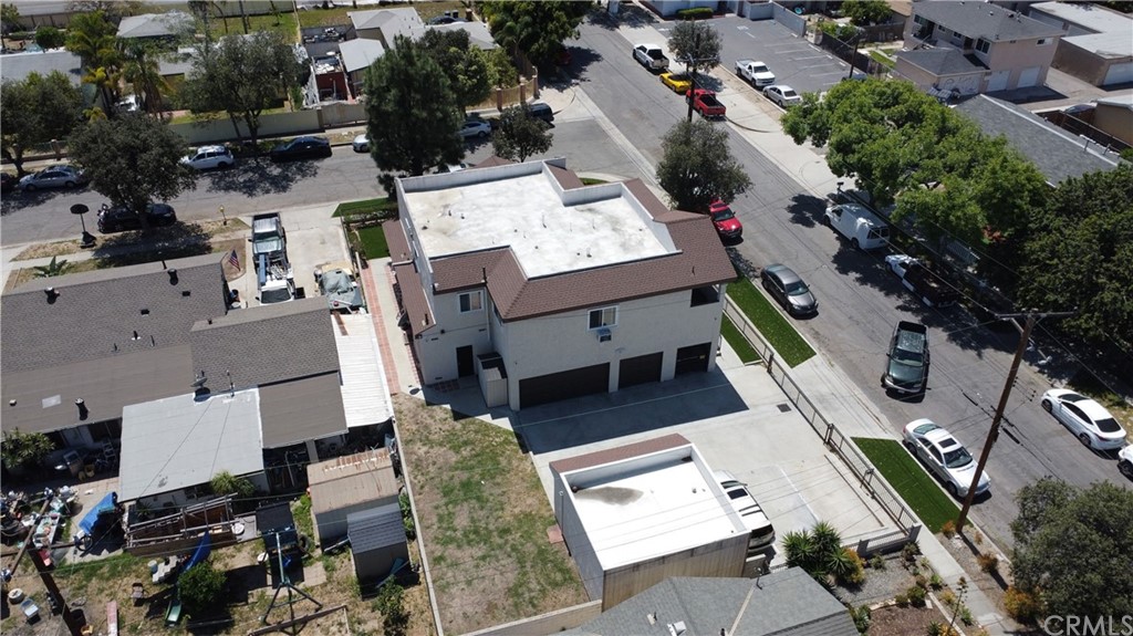 3419 Gregory Avenue Fullerton, CA 92833 - Photo 4 of 8 an aerial view of a residential apartment building with a yard and parking spaces