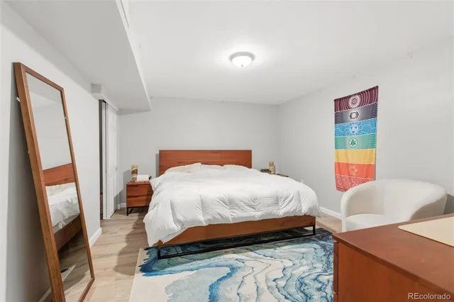 a bedroom with two beds and a lamp