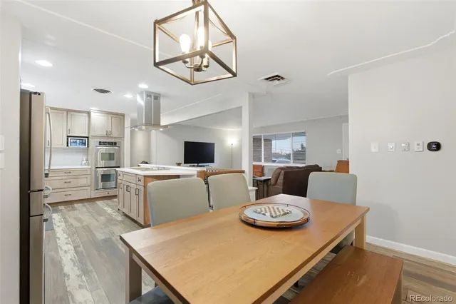 a living room with furniture and view of kitchen