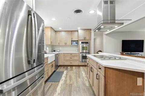 a kitchen with a stove a sink and a refrigerator