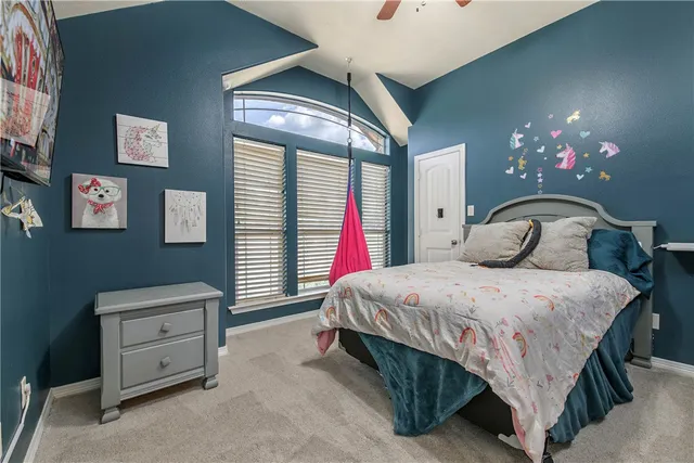 a bedroom with a bed and a chandelier