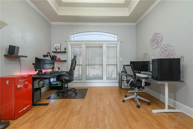 a view of a workspace with furniture and a flat screen tv