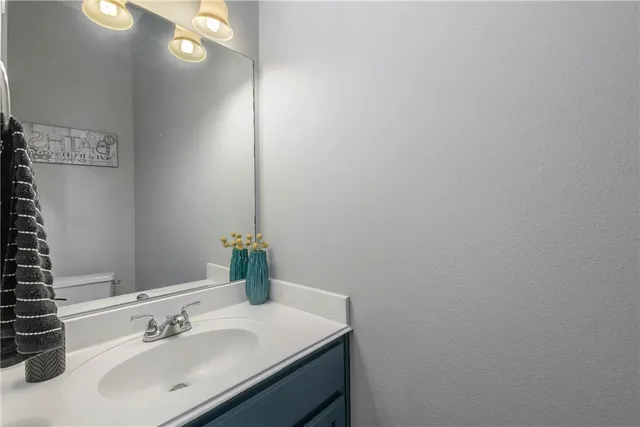 a bathroom with a sink vanity and a mirror