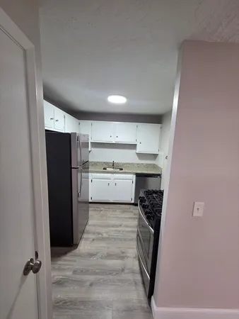a kitchen with a refrigerator a washer and dryer