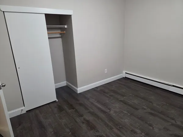 an empty room with wooden floor