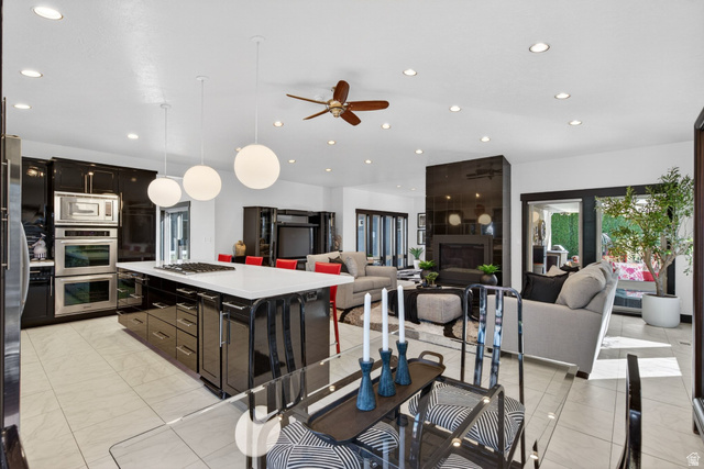 145 Carnesecca Court Mapleton, UT 84664 - Photo 109 of 109 Kitchen featuring ceiling fan, a center island, stainless steel appliances, open floor plan, and decorative light fixtures