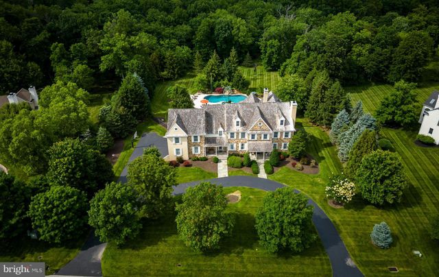 an aerial view of a house with swimming pool a yard and lake view
