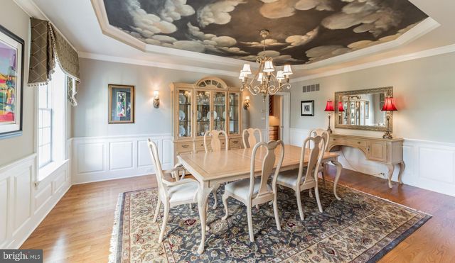 a view of a dining room with furniture and chandelier