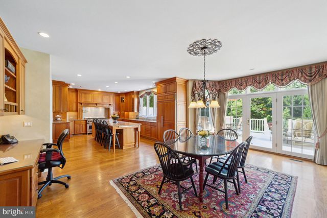 a view of a a dining room with furniture window and wooden floor