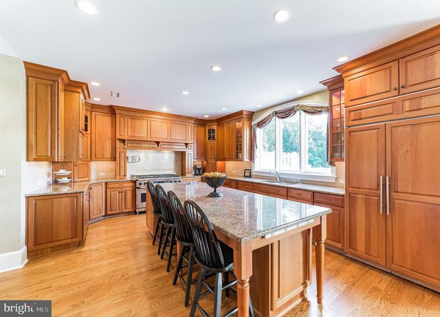 a stove top oven sitting inside of a kitchen