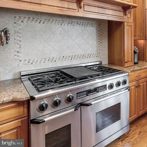 a living room with furniture a fireplace and a large window