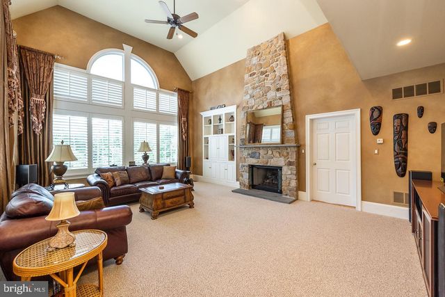 a living room with furniture and large windows