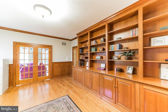 a view of staircase with wooden floor and a chandelier