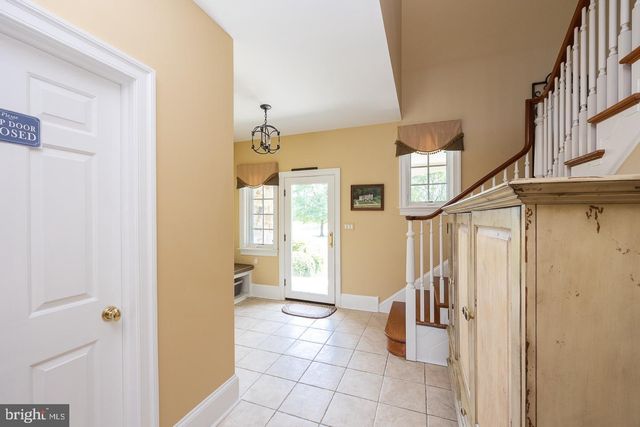 a view of a livingroom with a large window and wooden floor