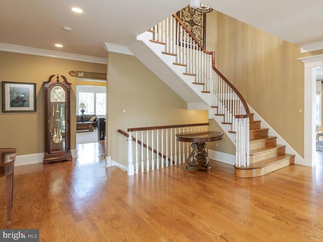 a spacious bedroom with a bed and ceiling fan
