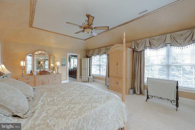 a bed room with a bed and a chair