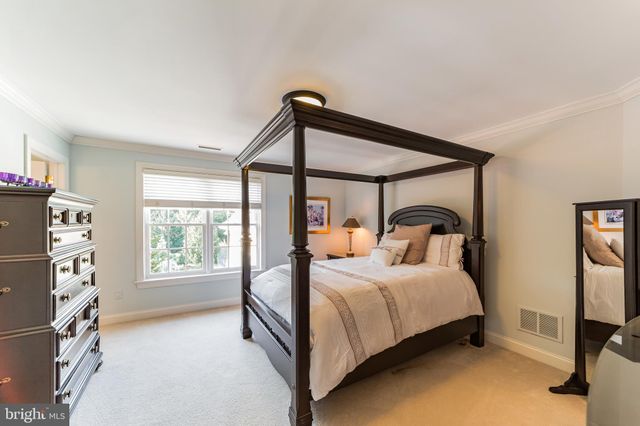 an aerial view of a house with a yard and greenery