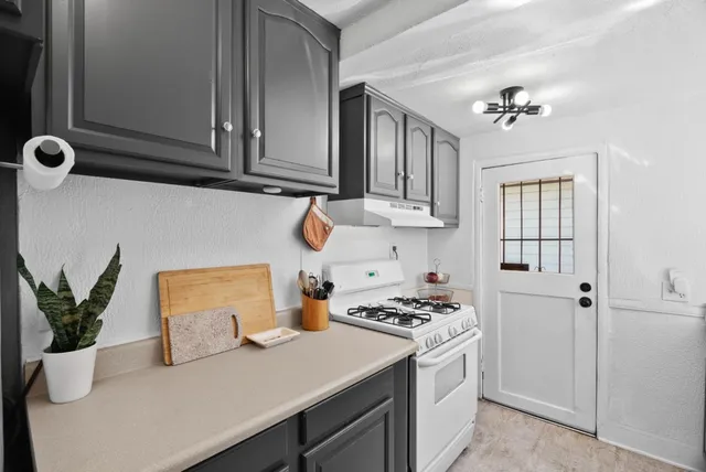 a kitchen with a refrigerator and cabinets