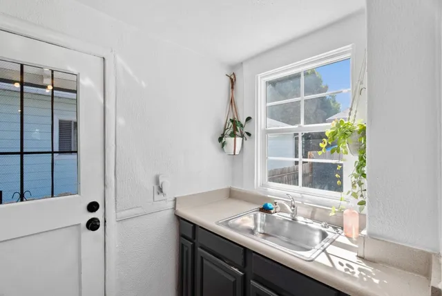 a bathroom with a granite countertop sink mirror and vanity