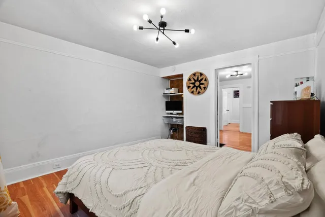 a bedroom with a bed and a chandelier