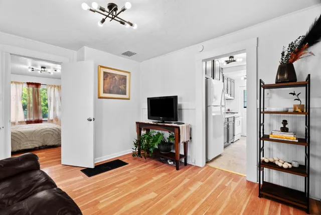 a bedroom with furniture and a flat screen tv