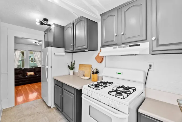 a kitchen with a stove and a refrigerator