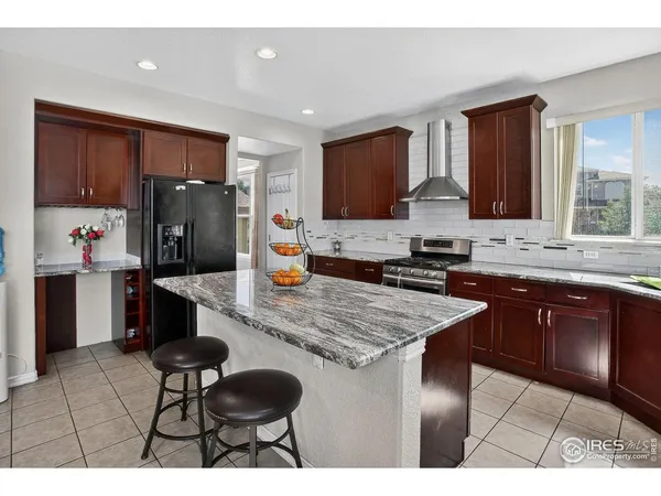 a kitchen with stainless steel appliances granite countertop a sink counter space and cabinets