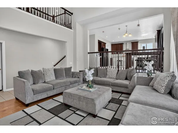 a living room with furniture or kitchen view and a chandelier