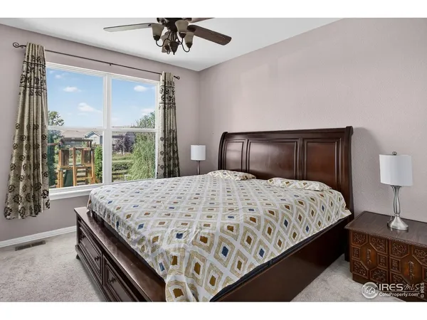 a bedroom with a large bed and a large window