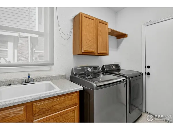 a utility room with a sink and a washer