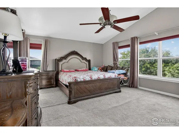 a living room with furniture and a ceiling fan
