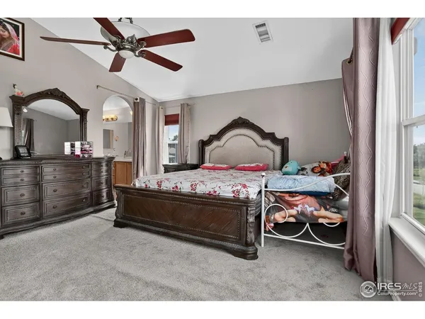 a bed room with furniture and a ceiling fan