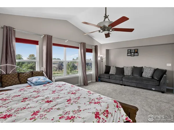 a bedroom with a large bed and a large window