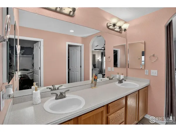 a bathroom with a sink double vanity and a mirror