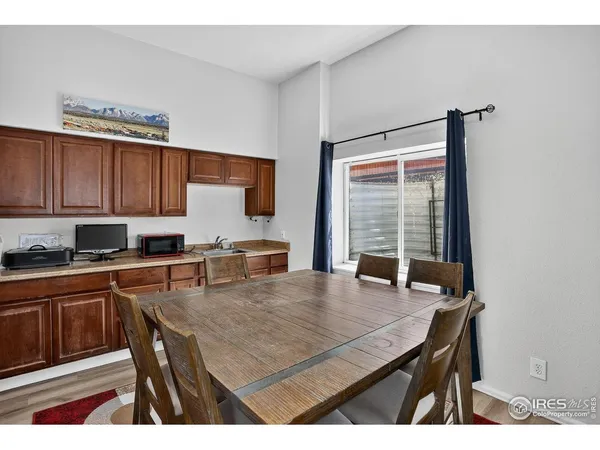 a kitchen with stainless steel appliances granite countertop a stove a sink dishwasher and cabinets with wooden floor
