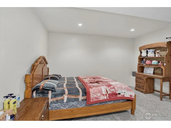 a bedroom with a bed and dresser