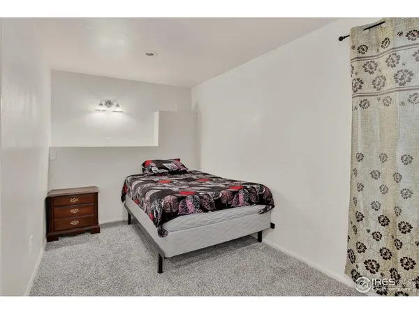 a bedroom with a bed and a tv