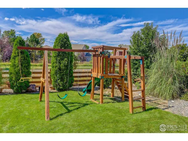 a view of a house with a backyard and a patio