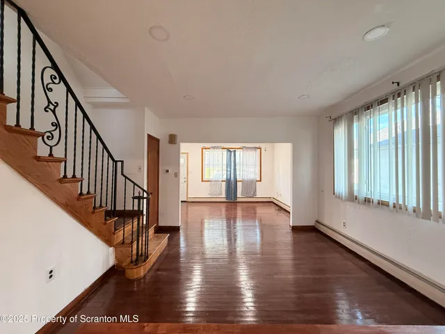 a view of an entryway with wooden floor