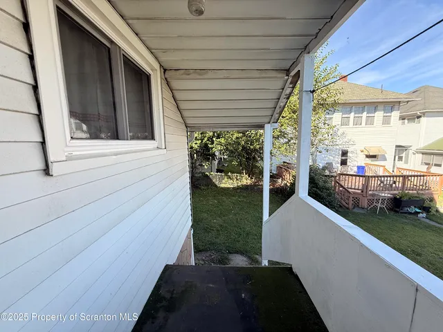 a view of a house with backyard and porch