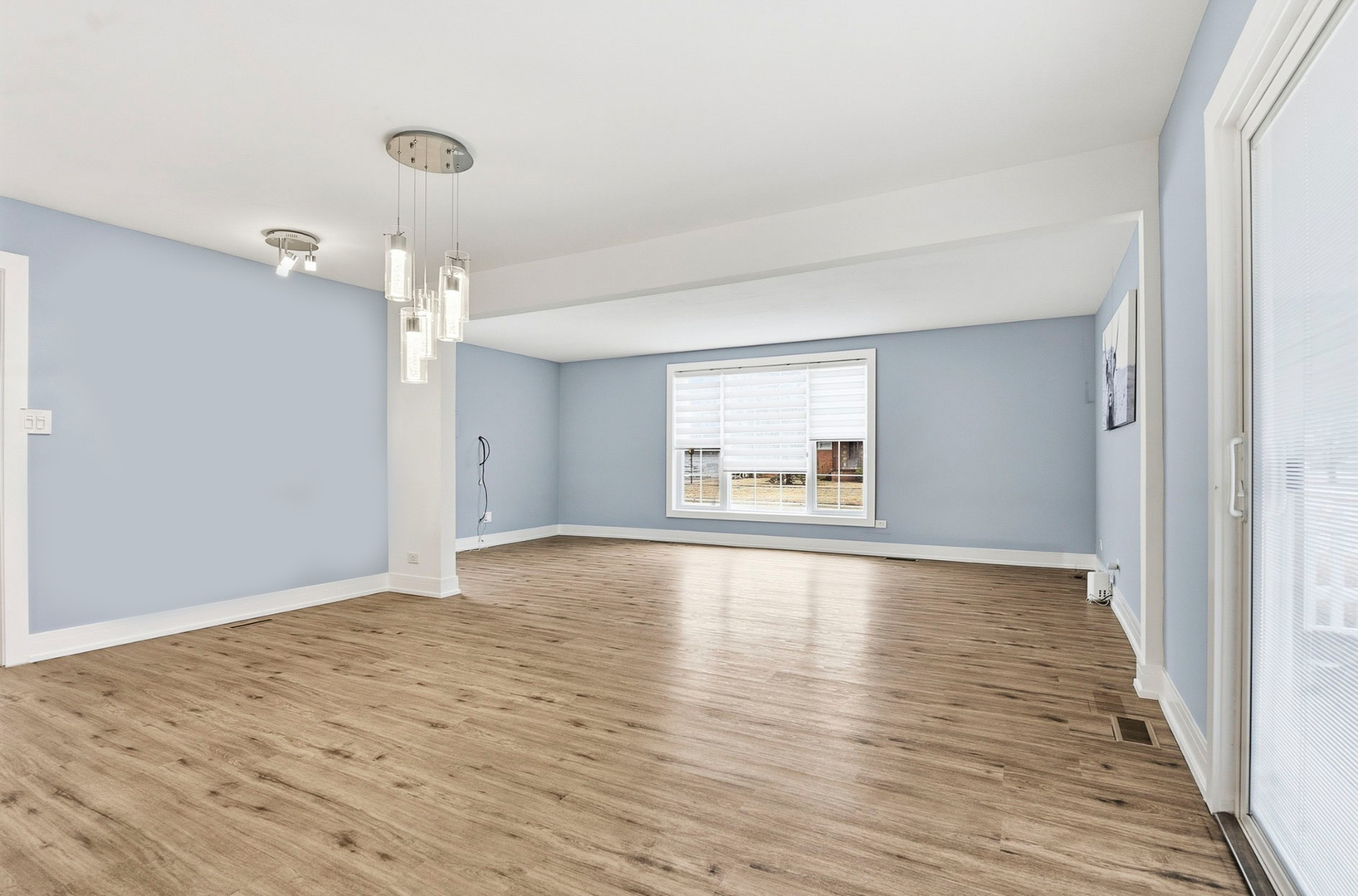 7303 West 75th Street Bridgeview, IL 60455 - Photo 11 of 48 a view of empty room with wooden floor and window