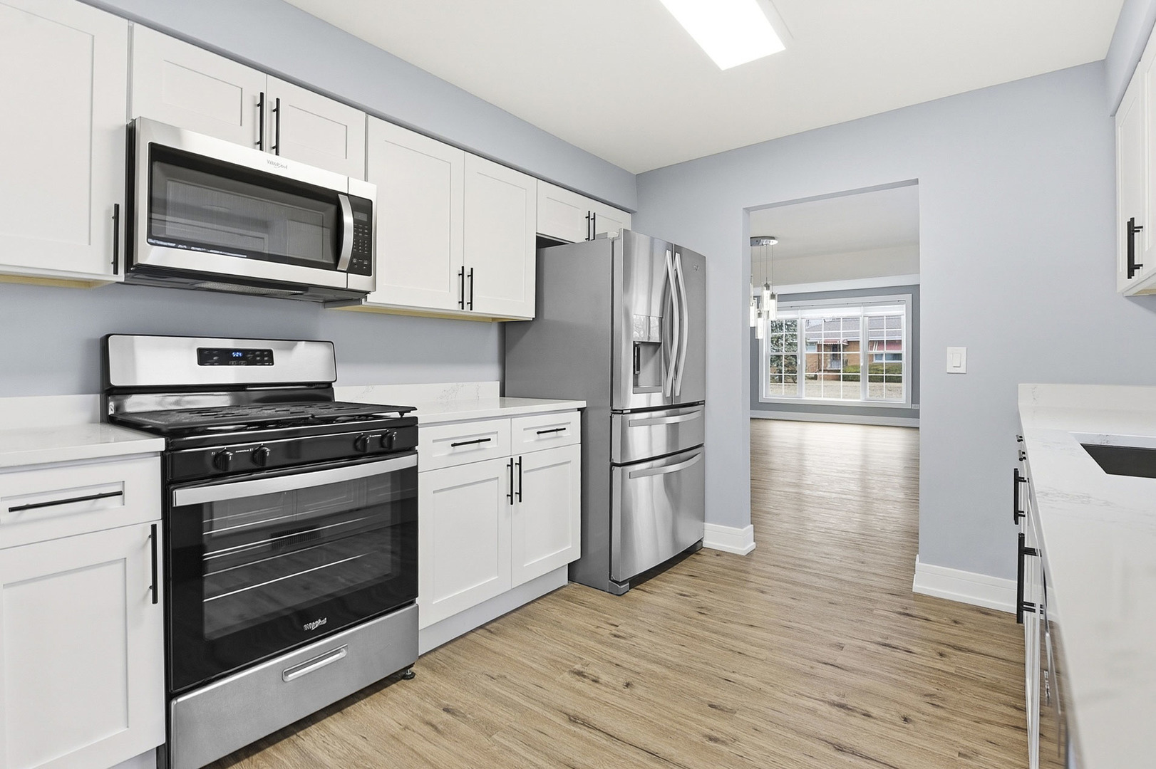 7303 West 75th Street Bridgeview, IL 60455 - Photo 13 of 48 a kitchen with stainless steel appliances a stove microwave and refrigerator