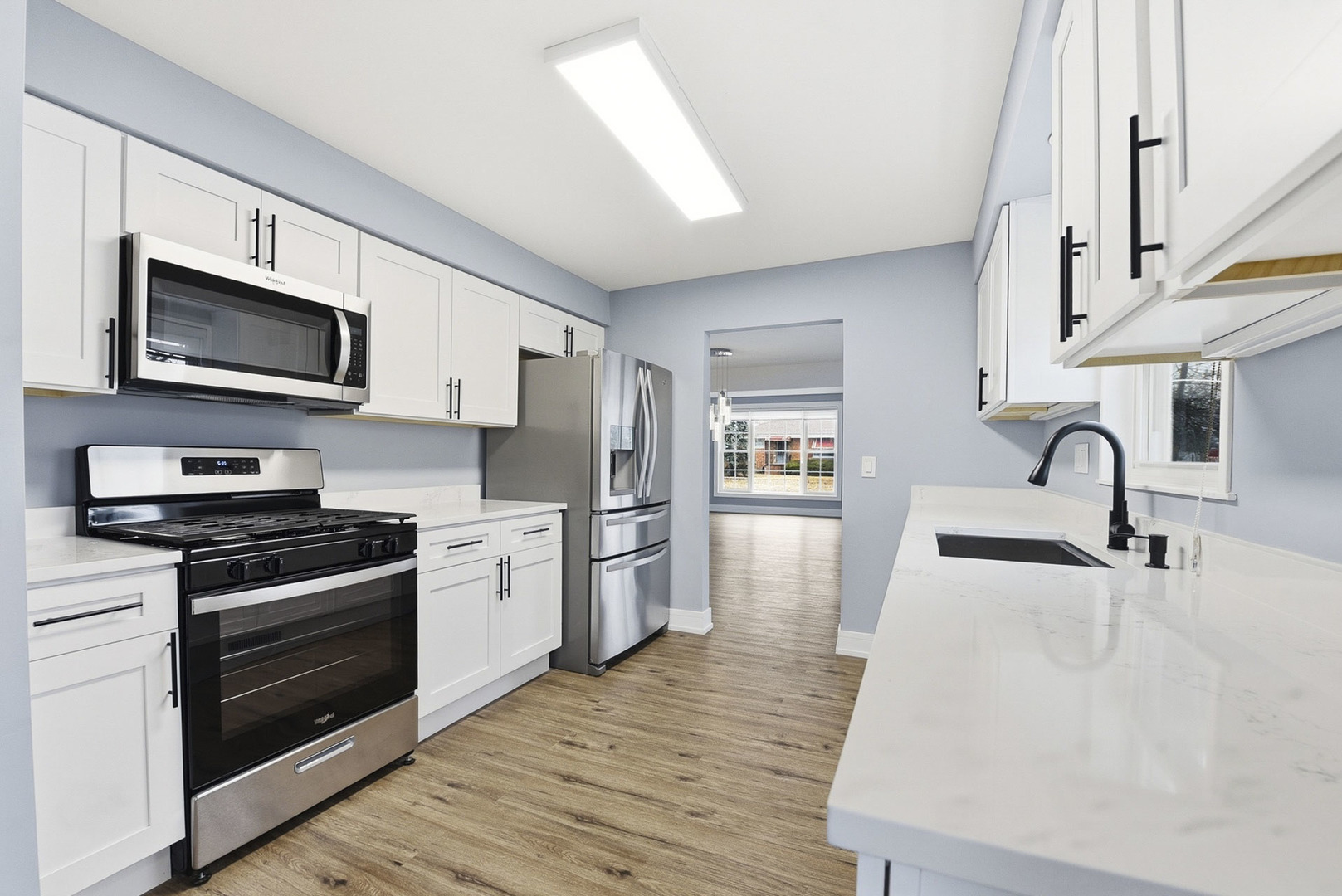 7303 West 75th Street Bridgeview, IL 60455 - Photo 15 of 48 a kitchen with stainless steel appliances a stove microwave and a sink
