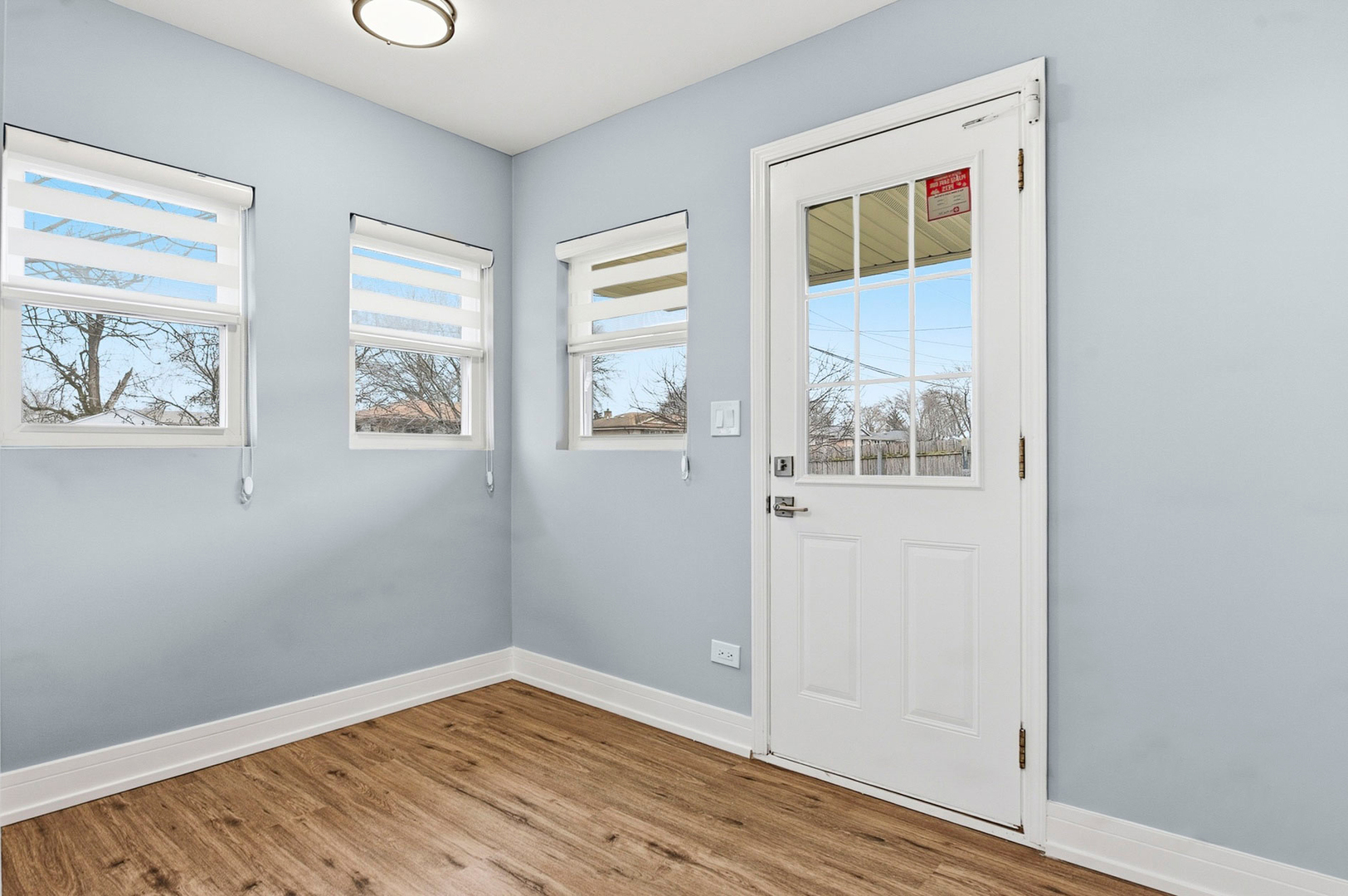 7303 West 75th Street Bridgeview, IL 60455 - Photo 17 of 48 an empty room with wooden floor and windows