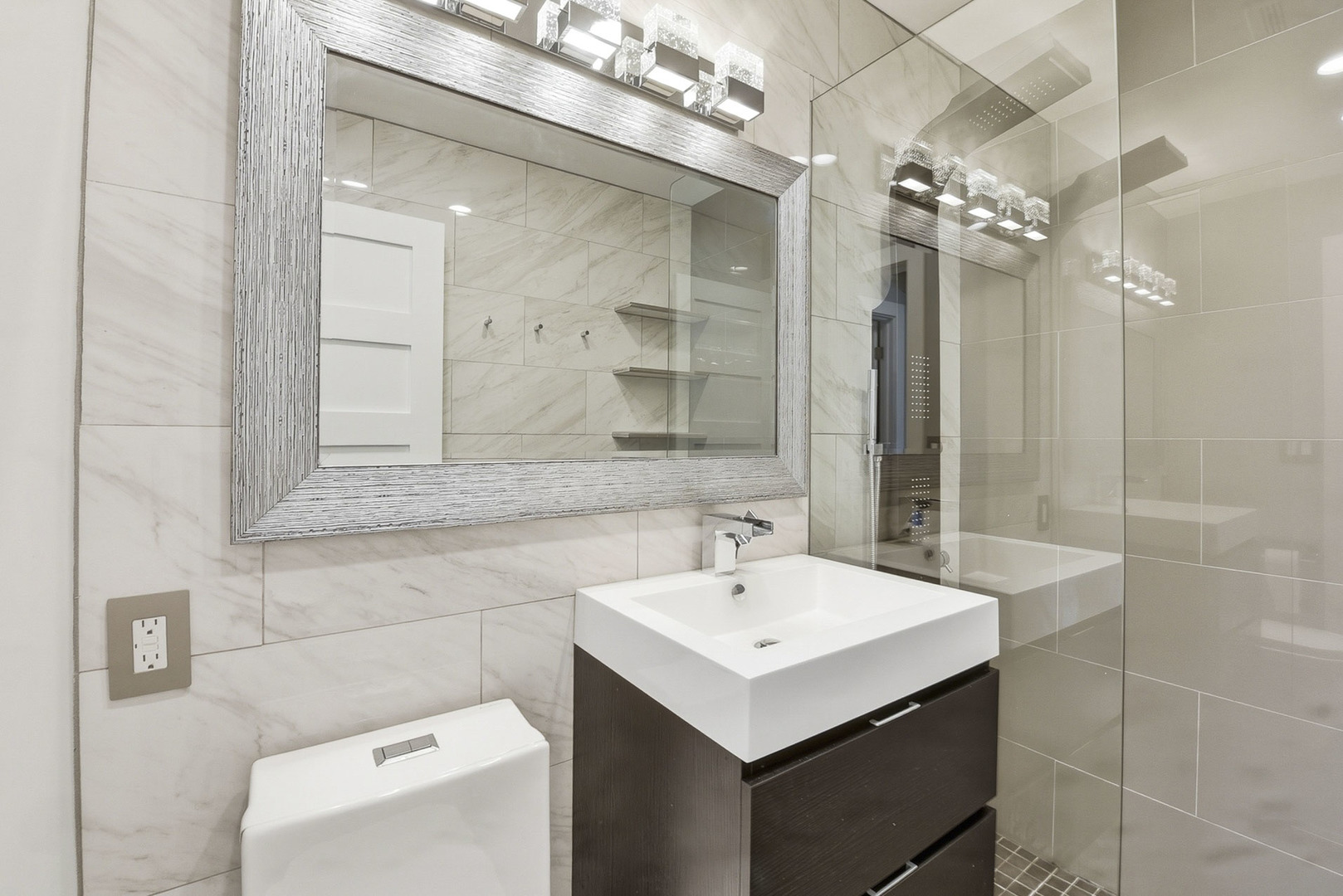 7303 West 75th Street Bridgeview, IL 60455 - Photo 21 of 48 a bathroom with a sink a toilet and shower