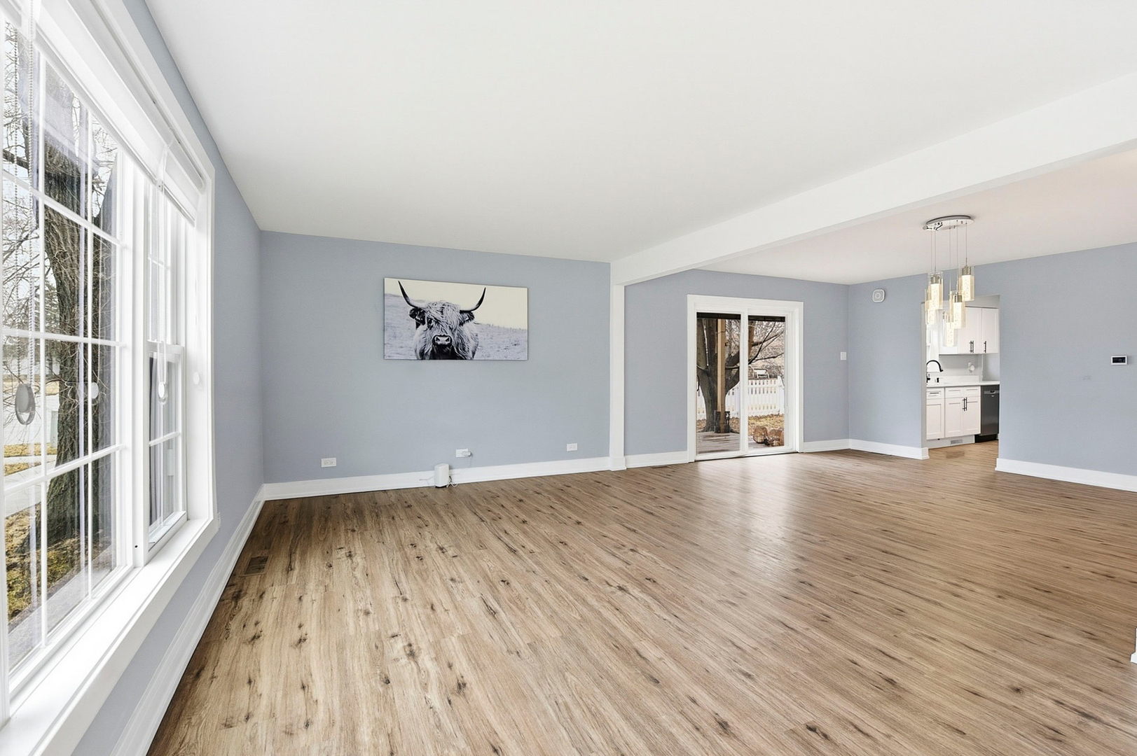 7303 West 75th Street Bridgeview, IL 60455 - Photo 7 of 48 wooden floor in an empty room with a window